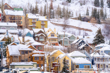 Fototapeta na wymiar Beautiful homes sitting on snow covered hill in Park City Utah viewed in winter