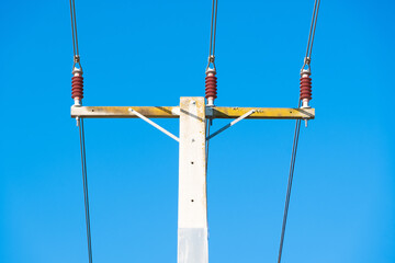 An electric pole in the blue sky background
