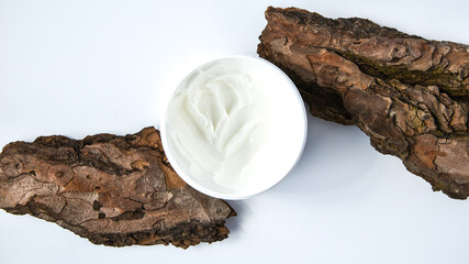 The concept of natural and natural cosmetics for personal care. Cream on a tree bark.