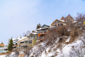 Fototapeta na wymiar Homes with snowy roofs and balconies in scenic Park City Utah neighborhood