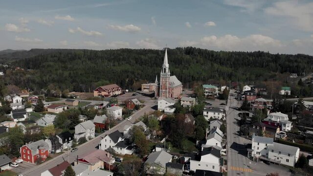 Flying Over The Le Bic Village With Sainte-Cecile du Bic Church On The Background In Bas Saint Laurent In Rimouski, Quebec, Canada.  - aerial drone