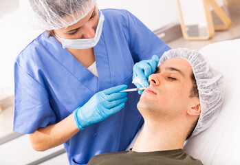 Man receiving facial contouring injections