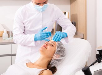 Woman receiving rejuvenating facial injections