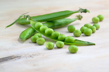 healthy fresh green peas and pods on rustic background, texture