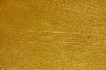 Scratches on aluminium metal texture background with gold color.