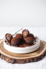 Vegetarian Chocolate Truffles With Raw Cocoa And Dates. Closeup View Of Pile Of Homemade Chocolate Truffles on white background. Chocolate Energy Balls