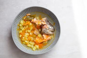 Top view of traditional Finnish soup with salmon, carrot  and potatoes