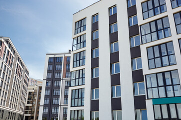 Modern European residential apartment buildings quarter on a sunny day with a blue sky.Abstract architecture, fragment of modern urban geometry