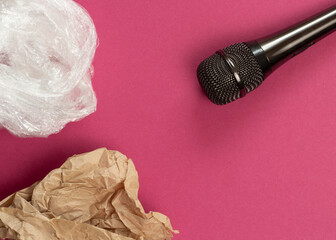 ASMR concept. Specific auditory irritants. Soap, plastic wrap and wrinkled paper lie in front of the microphone. Top view, flat lay.
