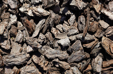 Crushed tree bark texture background closeup.Pieces of trunk.Old tree bark background or texture.Shredded brown tree bark for decoration and mulching or for playground
