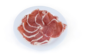 Tenderized boneless raw pork chops on the white dish