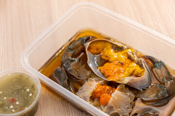Crab in Fish-Sauce Marinated. Wooden background. Ready to eat