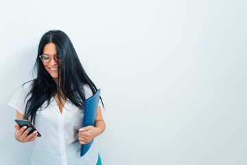 A beautiful Venezuelan woman smiling with a smartphone while making a video call.