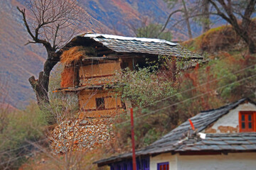 It look like a house on hills But in actual its a wood storage hut  where all the woods are  stored used for cooking food by small village  of 5 to 6 houses.