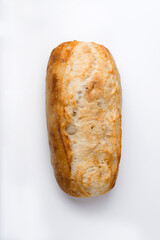 Small french baguette isolated on light background.