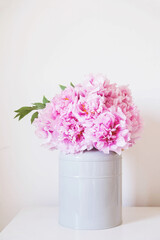 Fototapeta na wymiar Beautiful bouquet of fresh pink peony flowers in full bloom in vase.