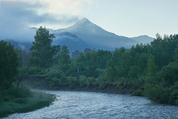 Obraz premium Morning on a mountain river, forested shores, light fog. Travel and summer vacation. 