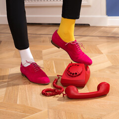 Luxury beautiful female legs in pink suede flat shoes with laces in yellow and white socks, next to...