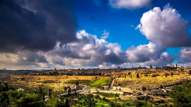 Beautiful time lapse of clouds rolling over Jerusalem with the Dome of the Rock, Golden/Mercy Gate, Old City wall and traffic in and out of St. Stephen's/Lions Gate, leading to Muslim Quarter