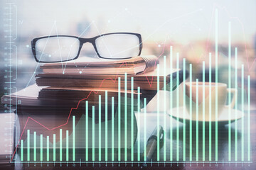 Financial graph hologram with glasses on the table background. Concept of business. Double exposure.