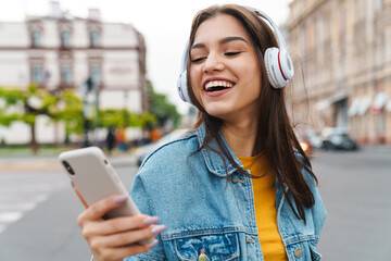 Image of woman listening music with smartphone and wireless headphones - obrazy, fototapety, plakaty