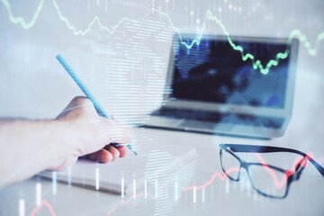 Multi exposure of man hands with stock market forex graph.