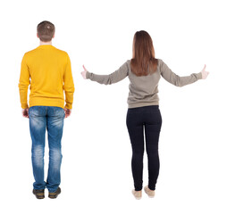 Fototapeta premium Back view of couple in sweater showing thumbs up.
