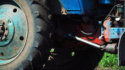 The tractor cultivates and cuts furrows in the field. Tractor work in the black soil field in the...