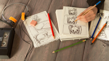 Artist drawing an anime comic book in a studio. Wooden desk, natural light. Creativity and...