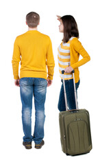 young couple in sweater traveling with suitcas.