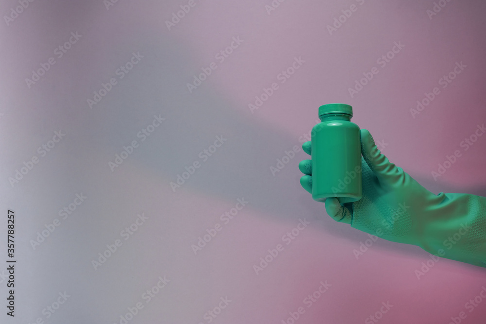 Poster beautiful hand hold green bottle for pills in the color light. beautiful old minimal in neon light. 