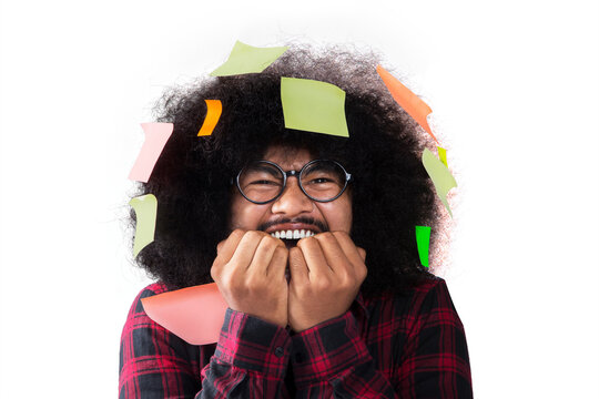 Frizzy man looks afraid with blank sticky notes