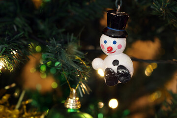 a snowman decoration on a christmas tree