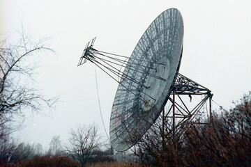 Radio telescope on the forest landscape. 
