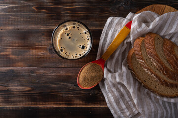 Top view homemade tradishional russian kvass in glass with foam and bread on napkin. Wonderful healthy refreshing drink for summer