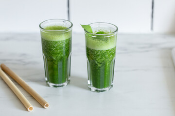 Healthy green vegan smoothie with spinach leaves, spirulina and snack for detox in summer days