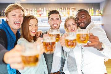 Lachende Gruppe Freunde beim Bier trinken