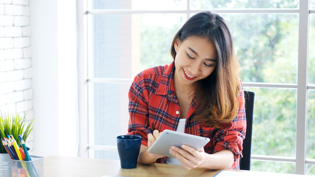 Asian woman using digital tablet at home office, Asia girl study online class, Female people making online chat, telecommunication technology, e commerce business, e learning education concept