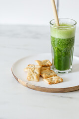 Healthy green vegan smoothie with spinach leaves, spirulina and snack for detox in summer days