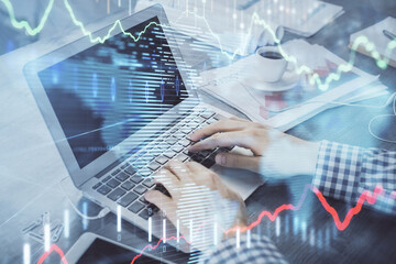 Double exposure of forex graph with man working on computer on background. Concept of market...