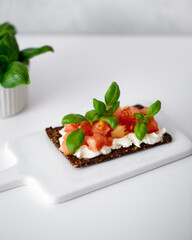 Open sandwiches with cream cheese, cherry tomatoes and basil