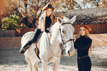 Girls with a horse. Women in a ranch. Blonde in a black sweater