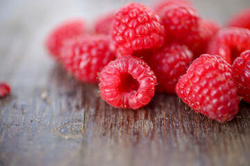 Close up view of fresh raspberries on a cutting board. Selected focus, space for text.