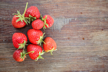 Close up view of fresh strawberries on a cutting board. Selected focus, space for text.