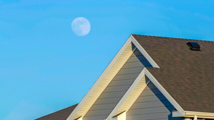 Panorama Facade of sunlit home in the suburb with vast blue sky background on a sunny day