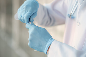 Medical student at the hall. Person in a white uniform. Coronavirus theme.