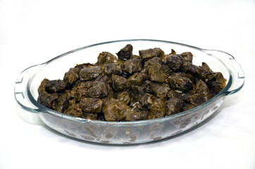 dolma, stuffed grape leaves in a bowl, turkish and greek cuisine . Azerbaijan meal, stuffed grape leaves, rice and spices .
