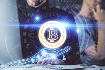 Crypto currency theme hologram with businessman working on computer on background. Concept of blockchain. Double exposure.