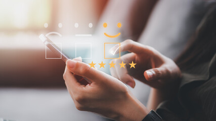Customer service satisfaction survey concept.Business people or customers show satisfaction through the application on the phone screen. By giving the most satisfaction rating and 5 stars.