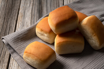 Dinner rolls set against an old wooden backdrop